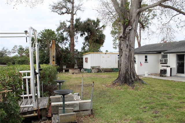 view of yard with a storage shed, cooling unit, and an outdoor structure