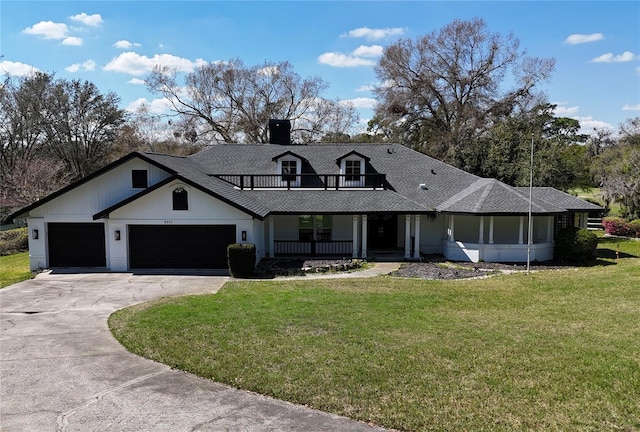 modern inspired farmhouse featuring a porch, a front yard, a balcony, a garage, and driveway