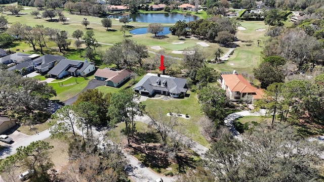 drone / aerial view featuring a residential view, a water view, and golf course view