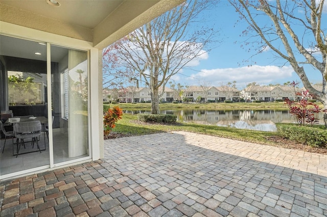 view of patio featuring a residential view and a water view