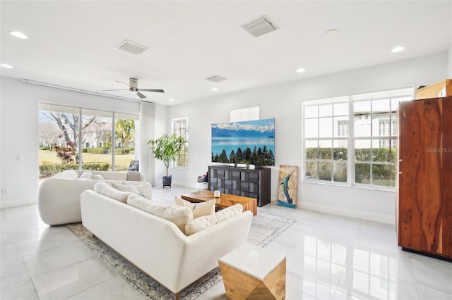 living area featuring light tile patterned floors, baseboards, visible vents, a ceiling fan, and recessed lighting