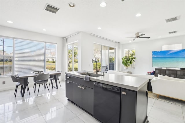 kitchen with plenty of natural light, black dishwasher, visible vents, and a sink