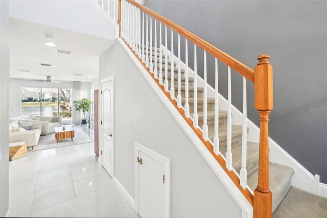 staircase with baseboards, visible vents, ceiling fan, and tile patterned floors