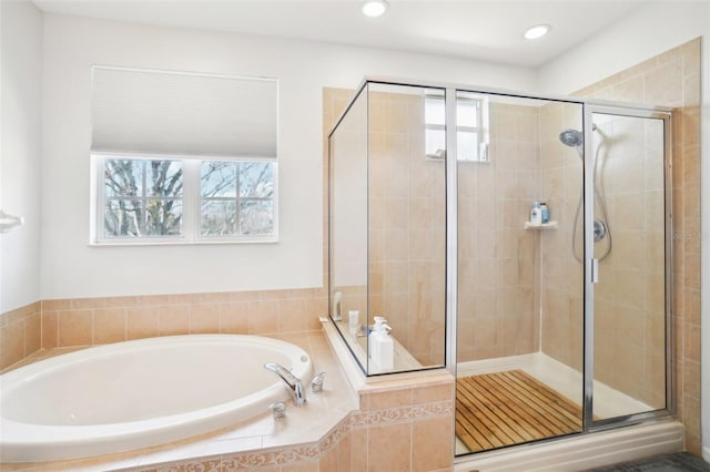 full bathroom with a stall shower, a garden tub, and recessed lighting