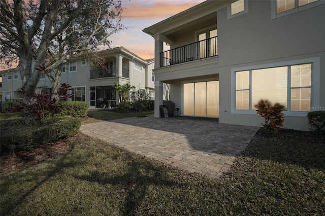 rear view of property featuring a patio area and stucco siding