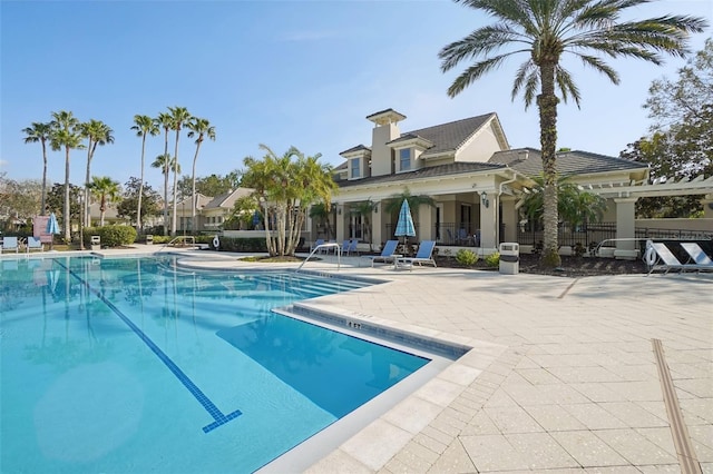 pool featuring a patio area and fence