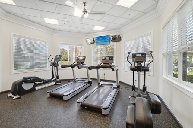 gym featuring ornamental molding, a drop ceiling, and baseboards