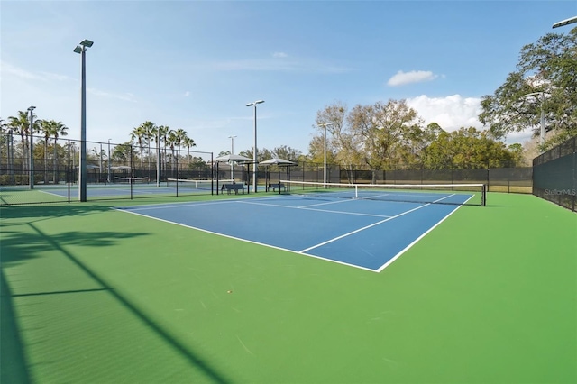 view of tennis court with fence