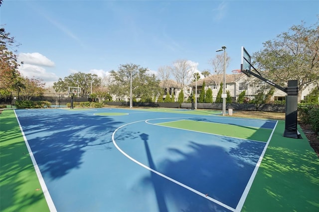 view of basketball court featuring community basketball court and fence