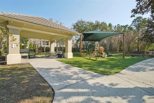 view of property's community featuring playground community, a lawn, and a gazebo