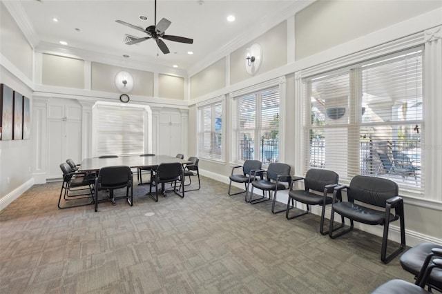 dining space with baseboards, ornamental molding, a high ceiling, and light colored carpet