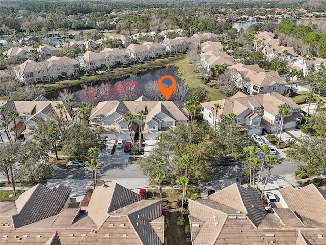 drone / aerial view featuring a water view and a residential view