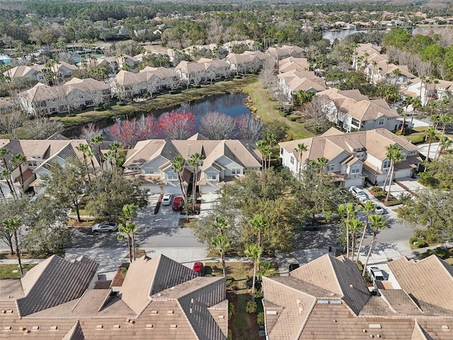 drone / aerial view featuring a water view and a residential view