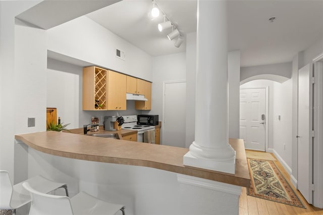 kitchen with black microwave, under cabinet range hood, white electric range, a sink, and visible vents