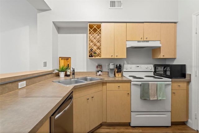 kitchen with electric stove, light countertops, under cabinet range hood, black microwave, and a sink