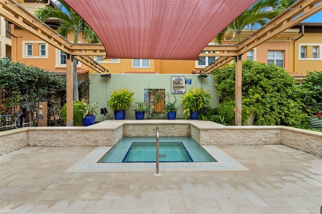 view of pool featuring a patio area and an in ground hot tub