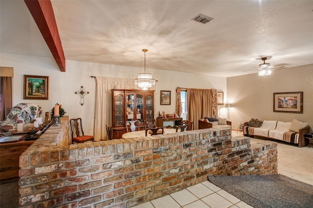 interior space with beam ceiling, visible vents, open floor plan, tile patterned flooring, and ceiling fan with notable chandelier