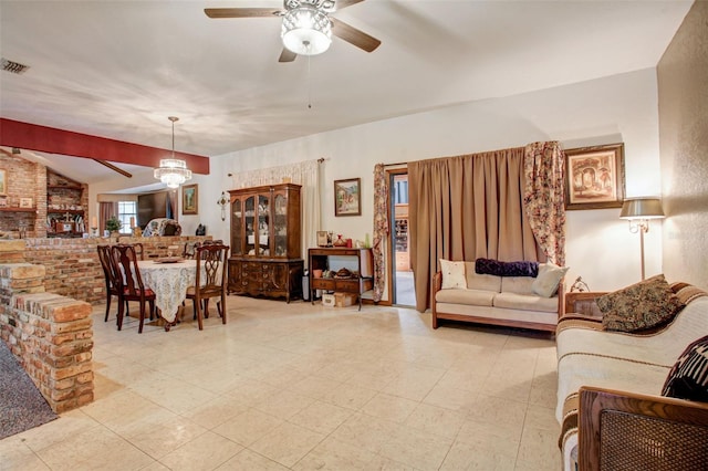 living area with lofted ceiling, visible vents, and ceiling fan with notable chandelier