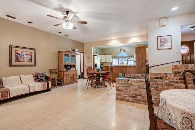 living room featuring a ceiling fan, recessed lighting, visible vents, and light floors