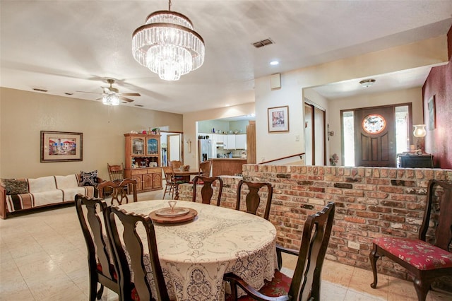 dining room with visible vents and ceiling fan with notable chandelier