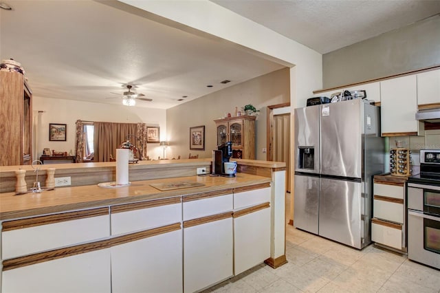 kitchen with stainless steel appliances, light countertops, a ceiling fan, white cabinetry, and under cabinet range hood