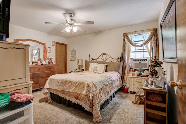 carpeted bedroom with ceiling fan and cooling unit