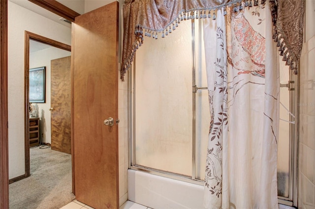 bathroom featuring shower / bath combination with glass door