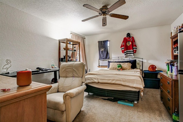 carpeted bedroom featuring a textured wall, a textured ceiling, and ceiling fan