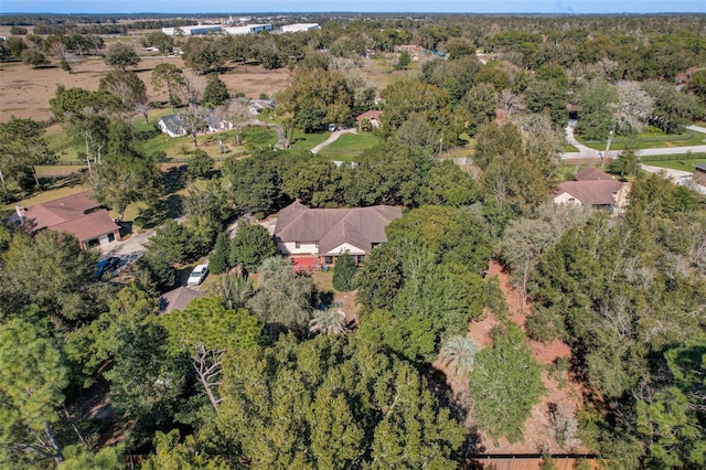 birds eye view of property with a wooded view