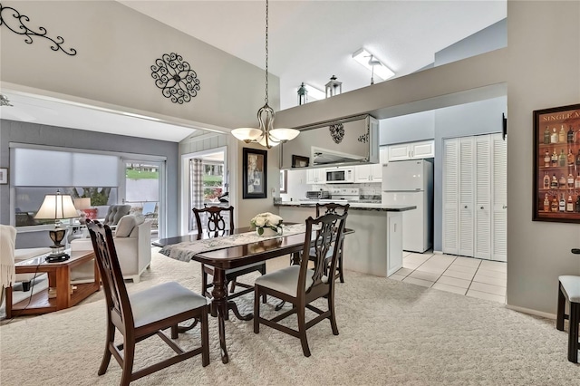 dining area with high vaulted ceiling, light tile patterned flooring, a notable chandelier, and light colored carpet