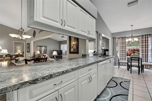 kitchen with visible vents, hanging light fixtures, white cabinets, vaulted ceiling, and white dishwasher