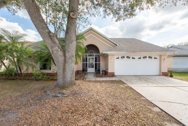 view of front of house featuring a garage, a shingled roof, concrete driveway, and stucco siding