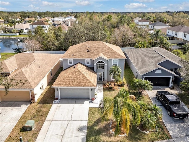 bird's eye view featuring a water view and a residential view