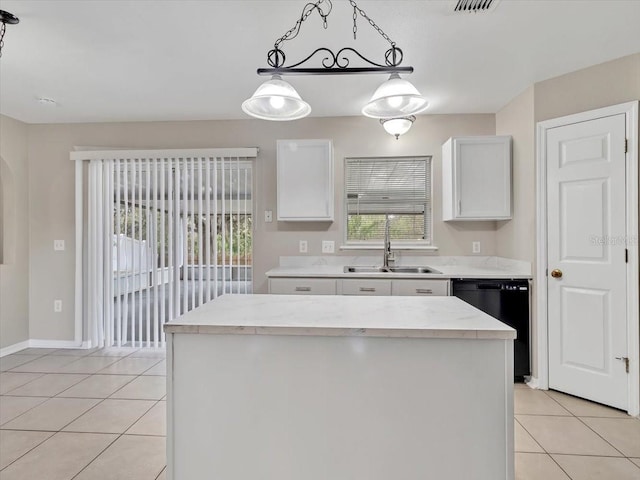 kitchen featuring black dishwasher, pendant lighting, white cabinets, a sink, and a kitchen island