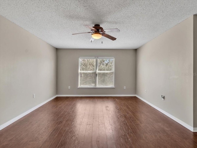 unfurnished room featuring a textured ceiling, dark wood-style flooring, a ceiling fan, and baseboards