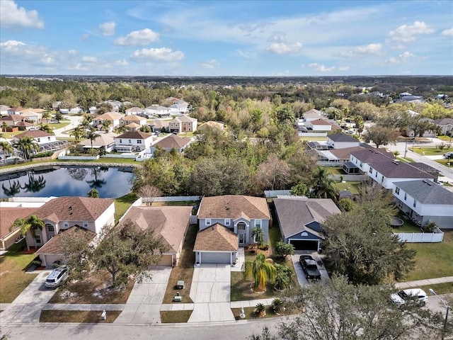 birds eye view of property with a water view and a residential view