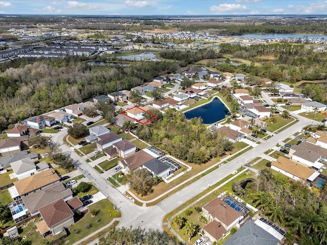 drone / aerial view with a residential view and a water view