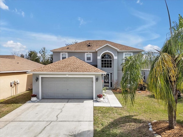 traditional-style house with stucco siding, concrete driveway, an attached garage, and a front lawn
