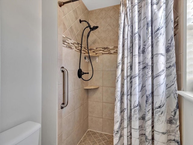 bathroom with a shower stall and toilet
