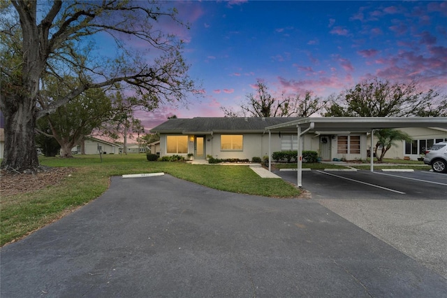 view of front of home featuring parking and a front lawn