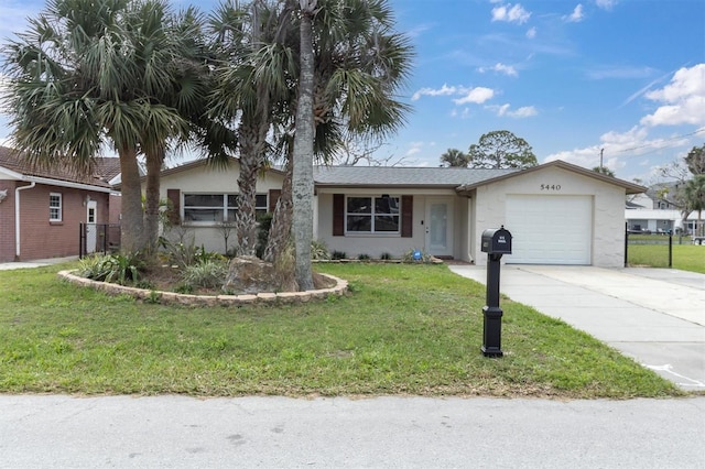 single story home featuring an attached garage, concrete driveway, a front yard, and stucco siding