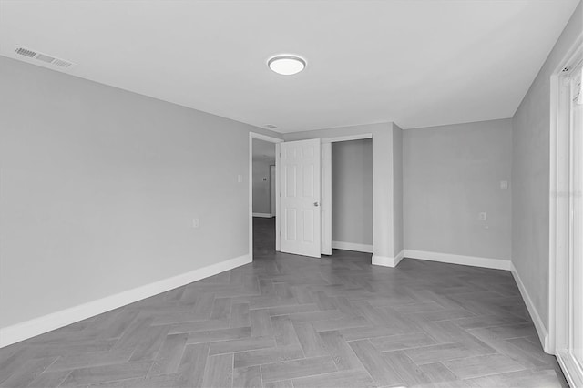 unfurnished bedroom with a closet, visible vents, and baseboards