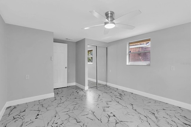 interior space with ceiling fan, visible vents, baseboards, marble finish floor, and a closet