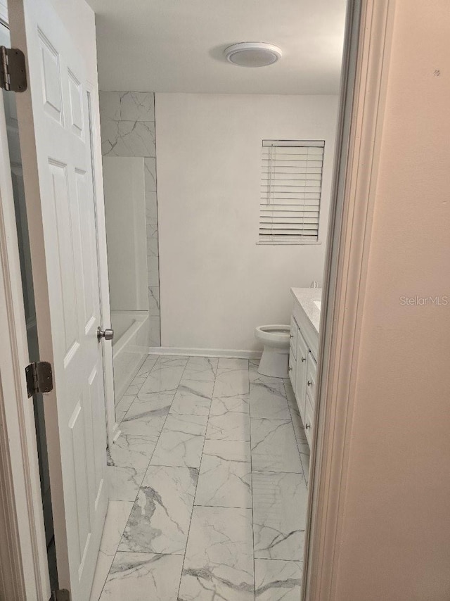 full bathroom with marble finish floor, vanity, baseboards, toilet, and shower / bathing tub combination