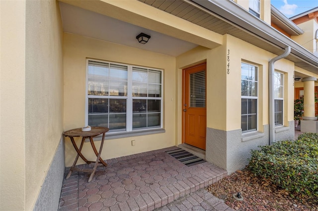 property entrance featuring stucco siding