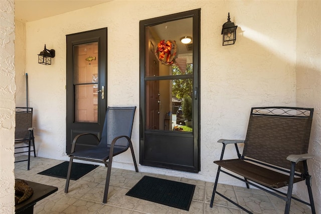 view of exterior entry with stucco siding