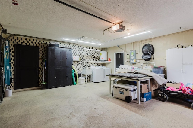 garage with water heater, independent washer and dryer, and a garage door opener