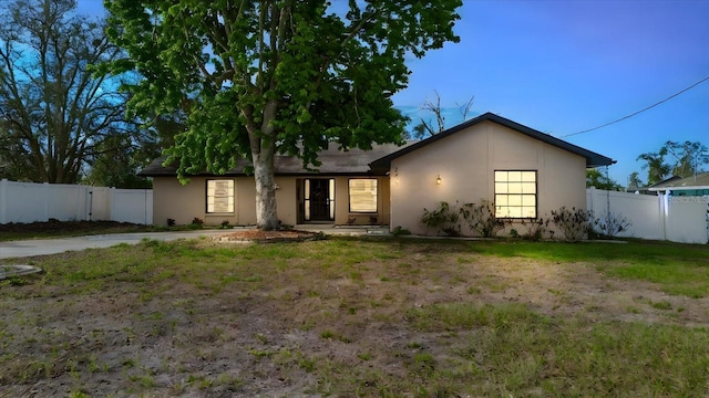 view of front of house with fence and stucco siding