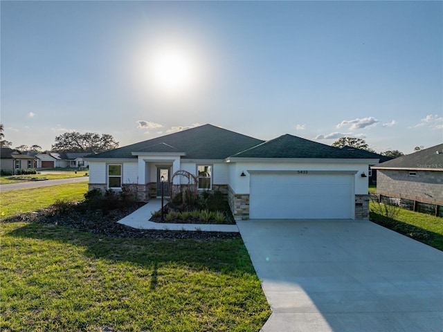 view of front facade featuring a garage, a front yard, concrete driveway, and stone siding