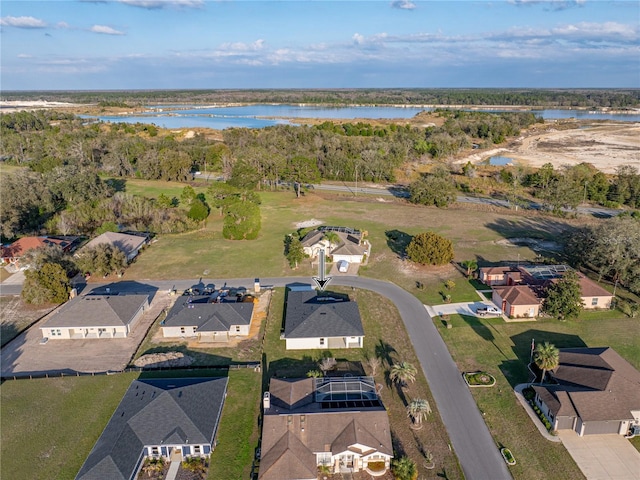 drone / aerial view with a water view and a residential view